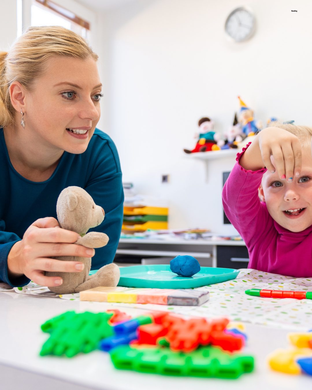 Pediatric occupational therapist working on fine motor and handwriting skills with a young child